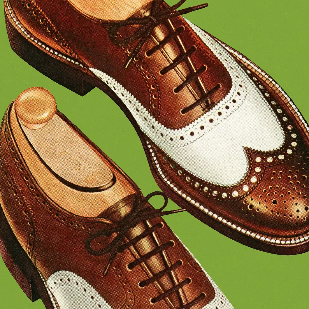 Brown and white men’s spectator shoes with brogue detailing – classic Kentucky Derby footwear style.