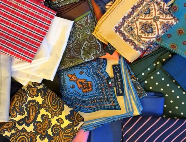 Silk, linen, and cotton pocket squares in vibrant spring colours and patterns, including paisley, checks, and polka dots, styled for Kentucky Derby race‑day elegance.